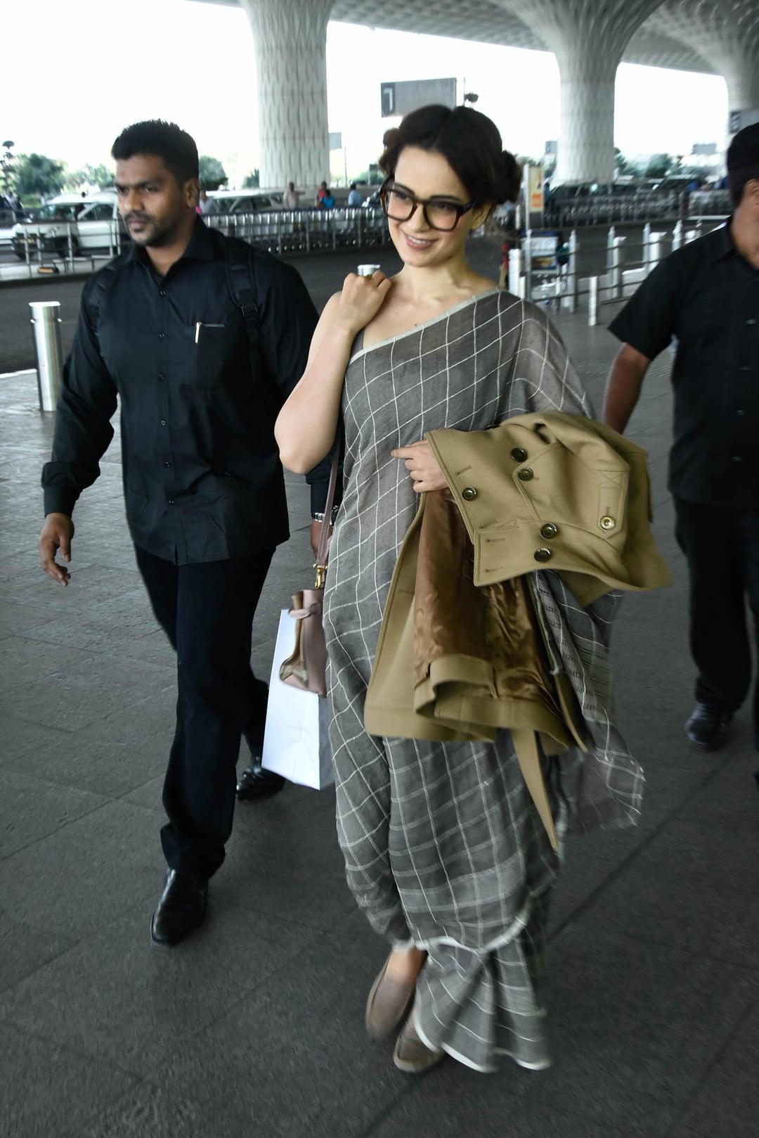 The grey saree, crafted with delicate draping and subtle embellishments, enhanced her grace and poise. The addition of glasses added an intellectual and trendy edge to her ensemble, making a statement that fashion can be functional.